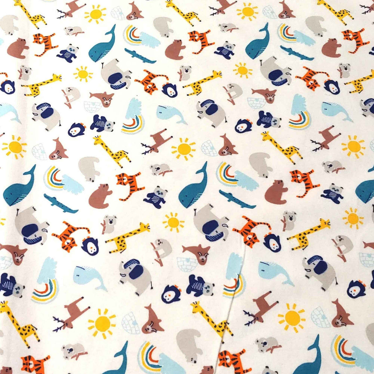 Safari animals cotton flannel fabric featuring whales, giraffes, tigers, bears, penguins, koalas, sloths, crocodiles, suns and rainbows on a white background.