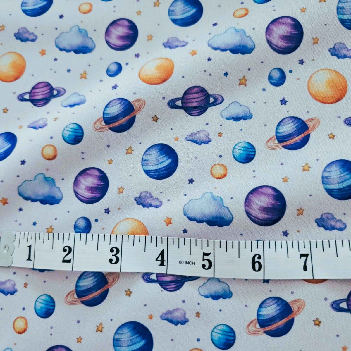 Dreamy Watercolour Planets and Clouds exclusive waterproof PUL fabric with colourful planets, blue clouds and stars on White