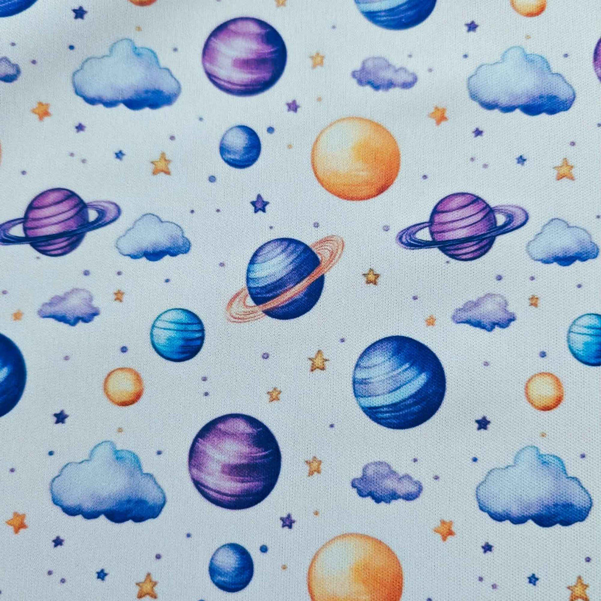Dreamy Watercolour Planets and Clouds exclusive waterproof PUL fabric with colourful planets, blue clouds and stars on White