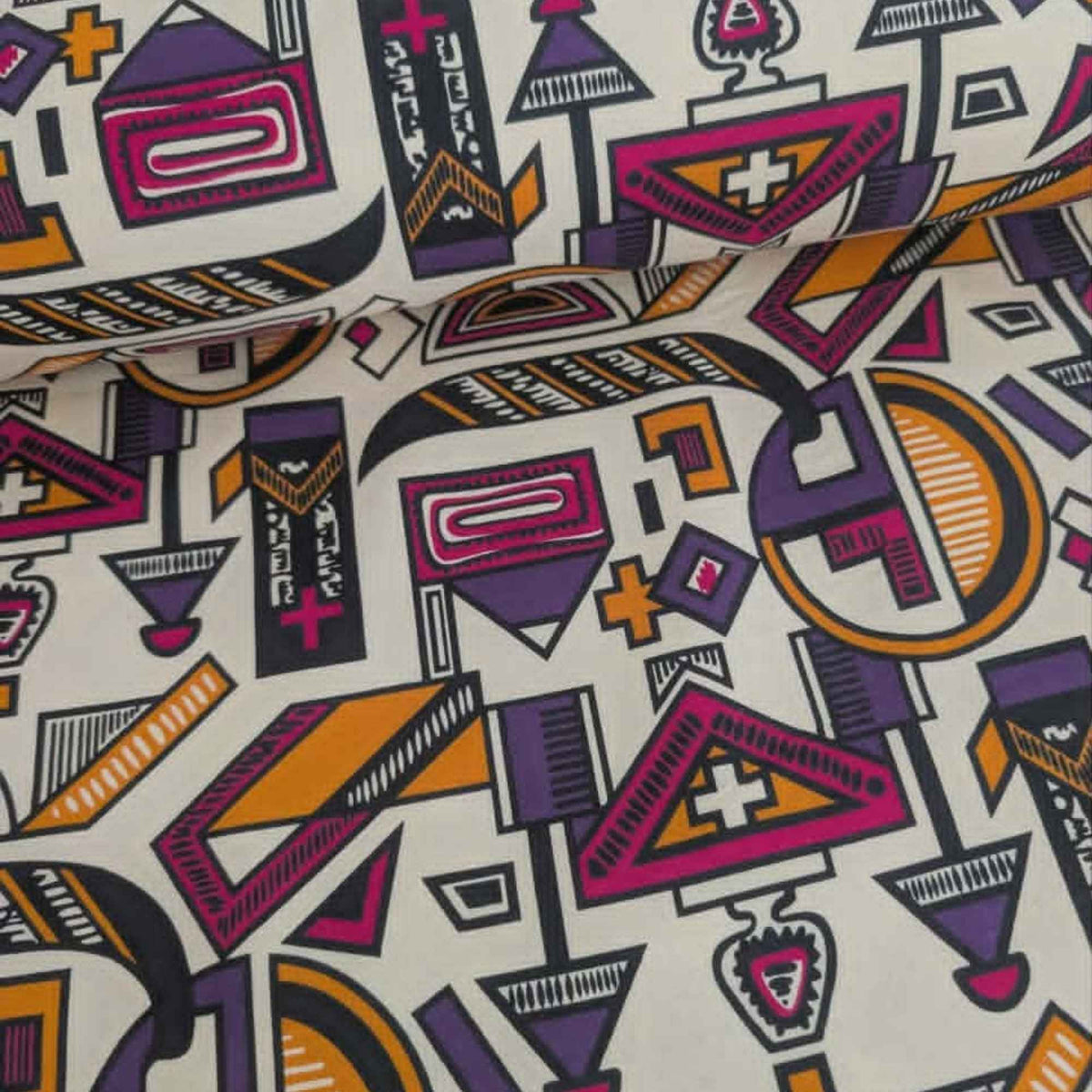African-inspired geometric tribal double brushed flannel fabric featuring colorful abstract geometric symbols on a cream background.