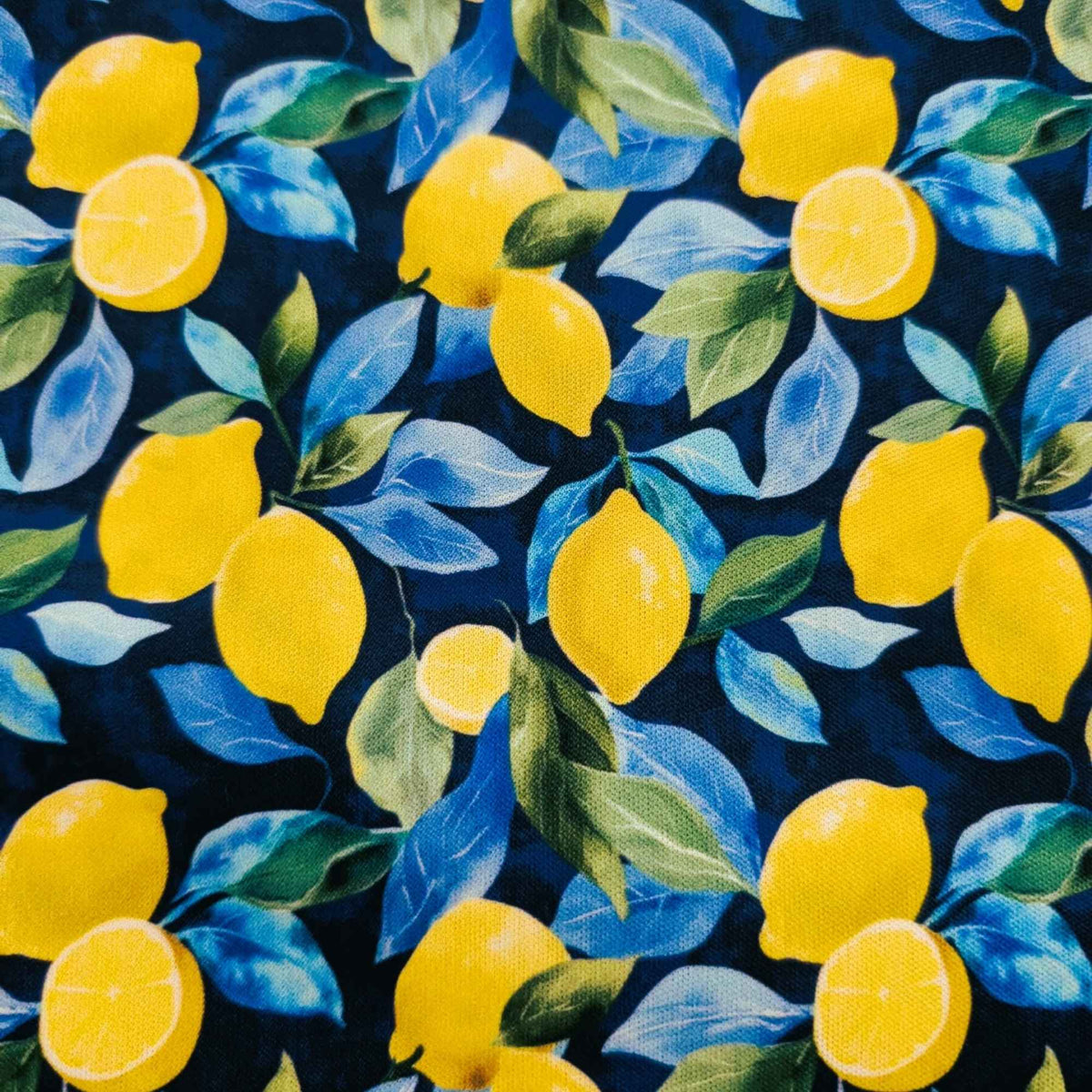 Sunlit Lemons on Navy exclusive waterproof PUL fabric with bright yellow lemons and blue-green leaves on a navy background