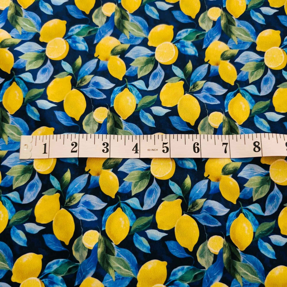 Sunlit Lemons on Navy exclusive waterproof PUL fabric with bright yellow lemons and blue-green leaves on a navy background