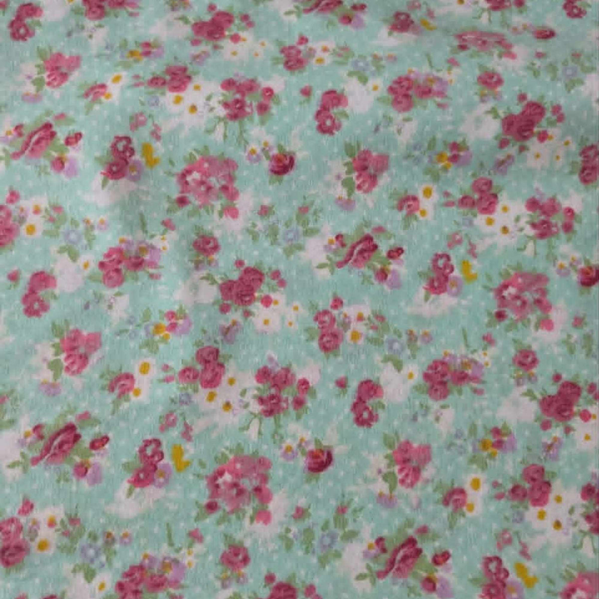 Double brushed flannel fabric featuring pink rose bouquets, delicate wildflowers, and floral sprigs on a soft mint green background.