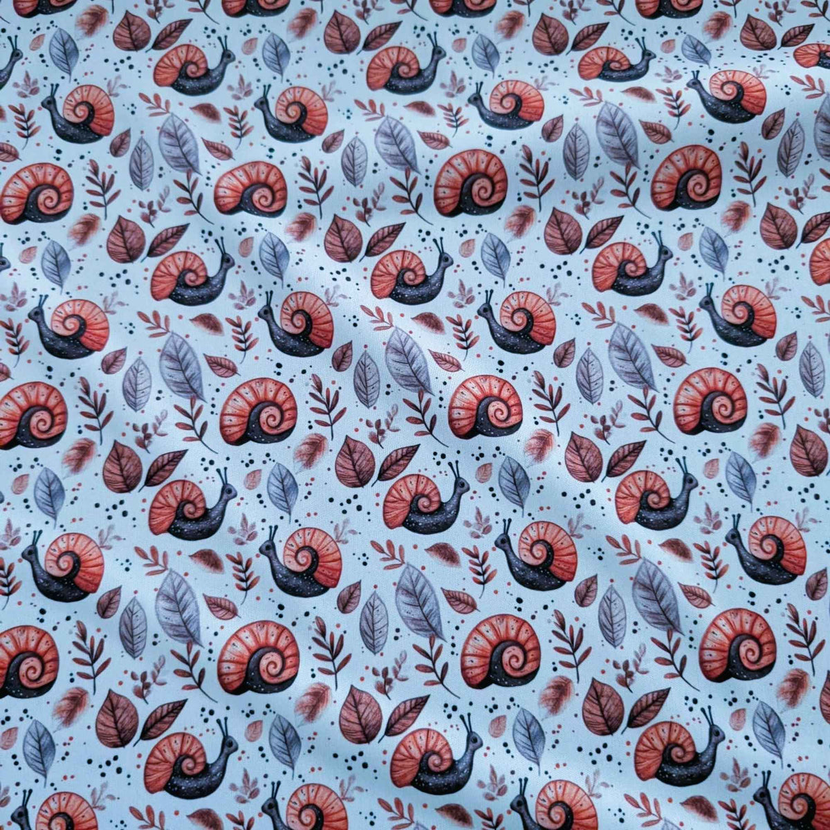 Woodland Snails and Autumn Leaves exclusive waterproof PUL fabric with orange-shelled snails and brown leaves on cream