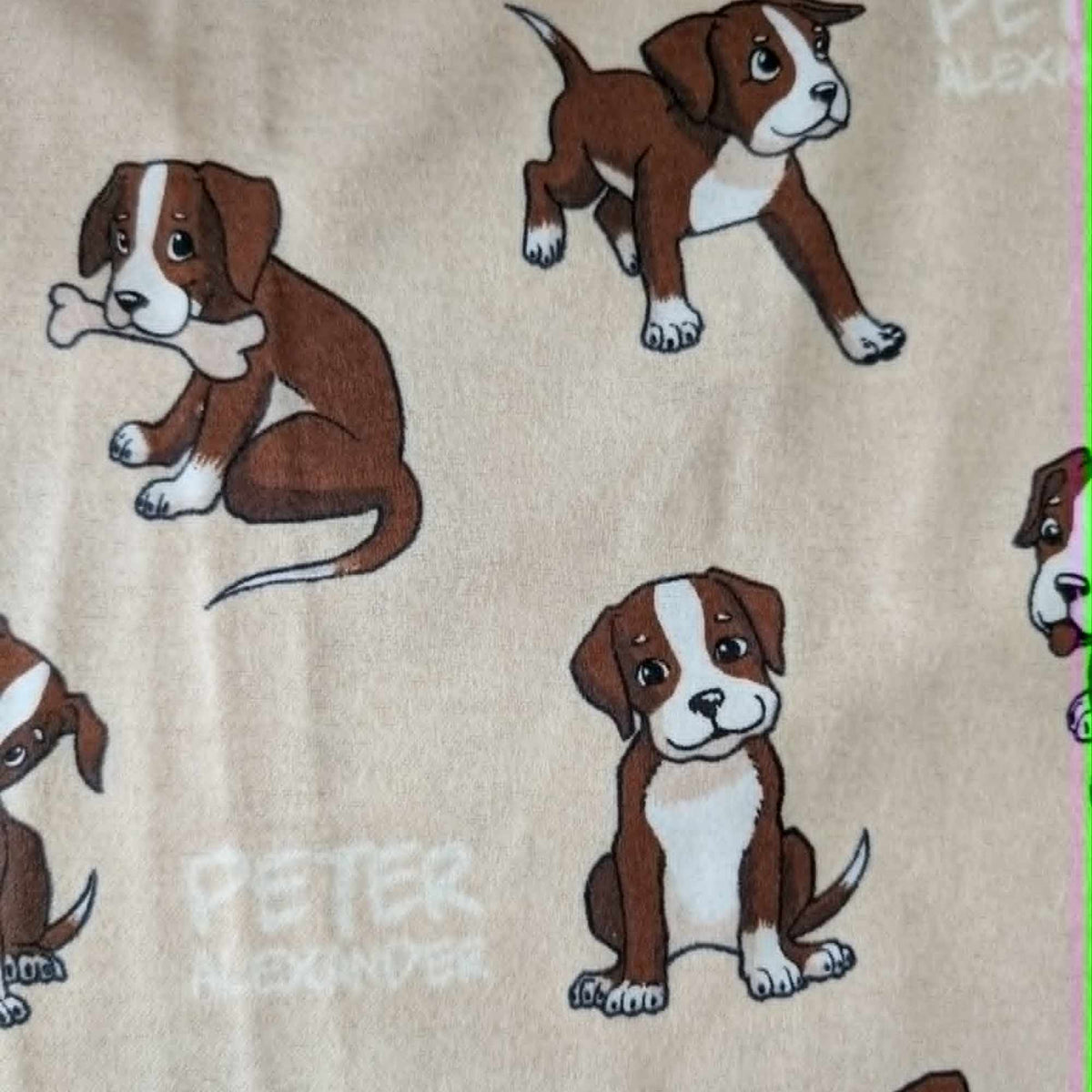 Double brushed flannel fabric featuring playful brown and white puppies in various poses on a cream background.