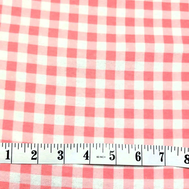 Red and white gingham checkered fabric shown with a 12-inch measuring tape along the bottom edge to indicate scale.