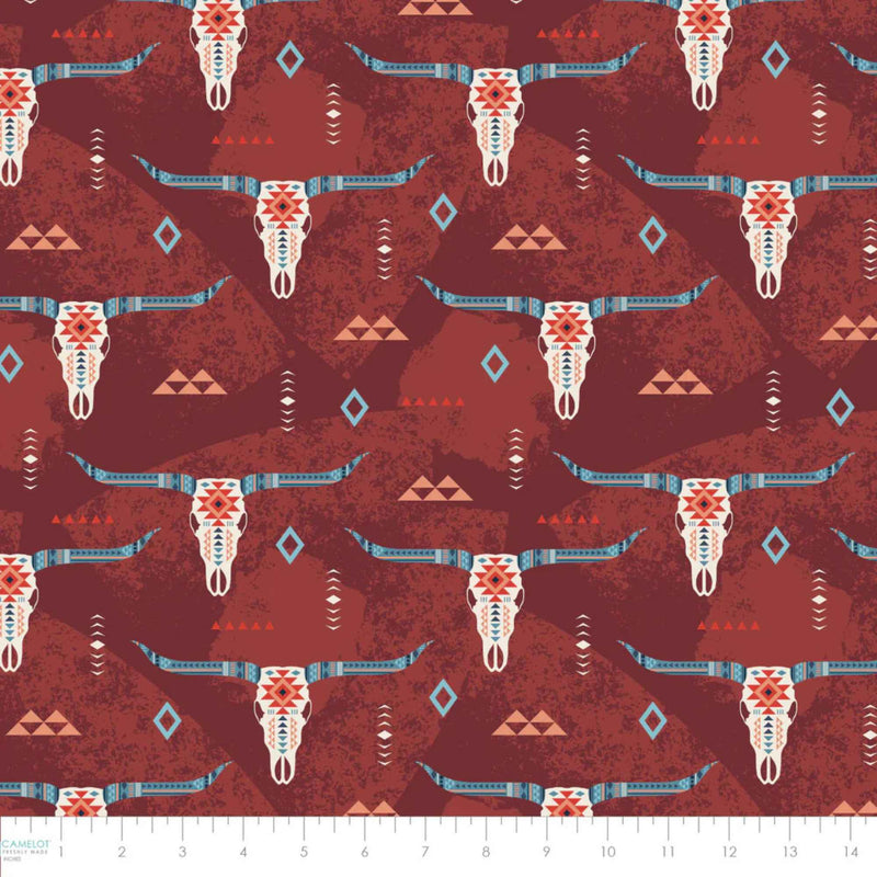“Rust-colored cotton fabric with Southwestern longhorn skull motifs and tribal geometric accents.”