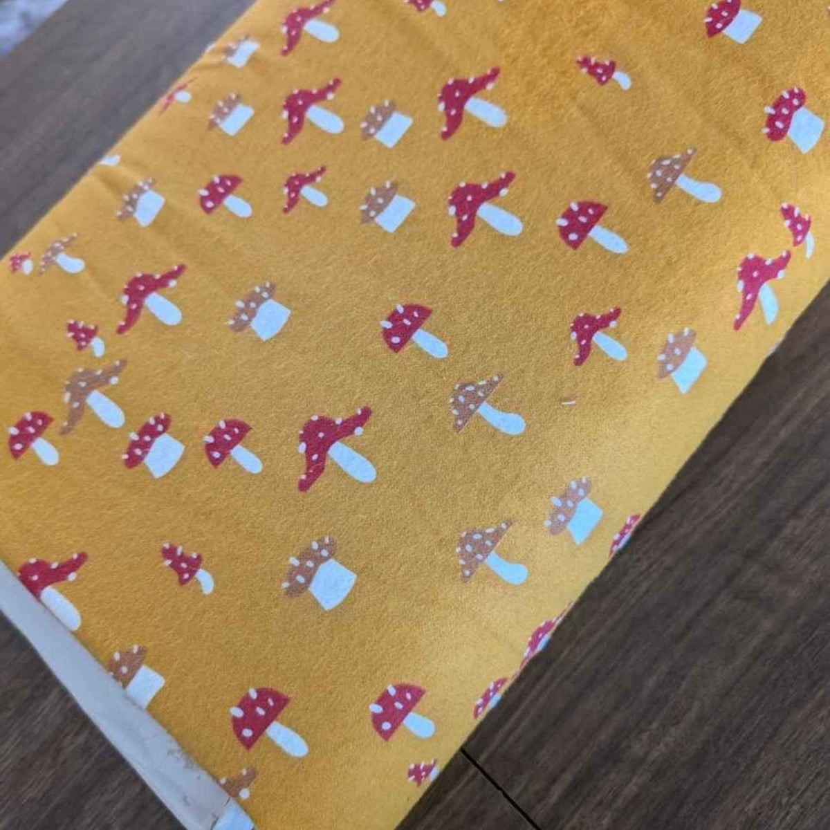 
Golden yellow flannel fabric with whimsical red and tan mushroom print – 100% cotton, soft and cozy for quilting, pajamas, and crafts