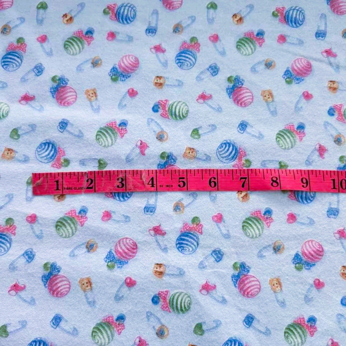 Baby Rattle and Safety Pins Flannel – Light Blue | 100% Cotton Nursery Fabric by Mai Designs