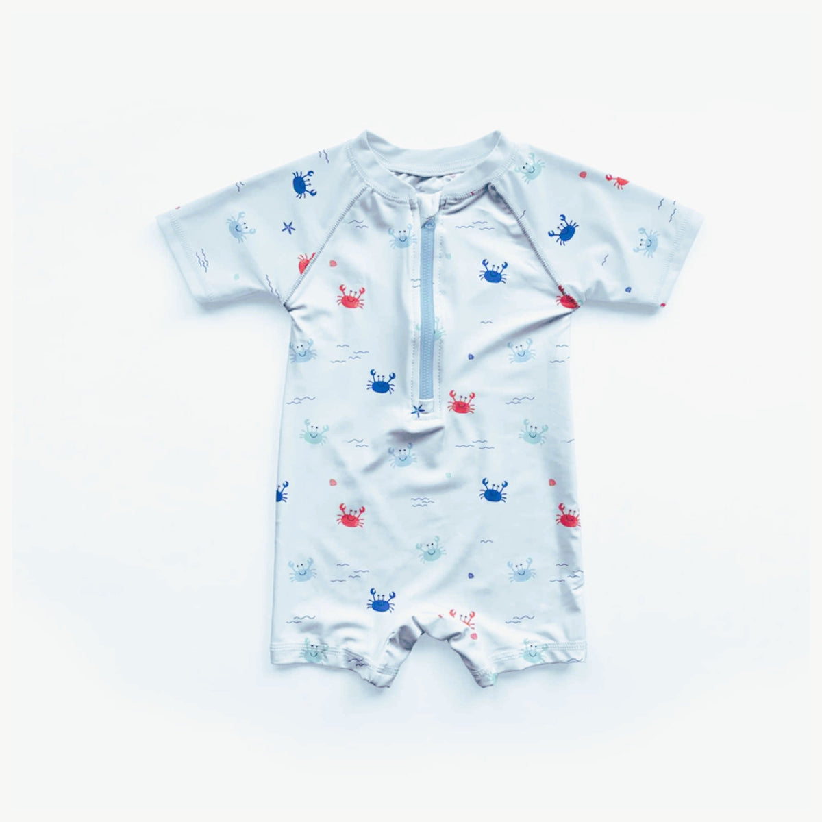 White swim fabric with playful red, blue, and mint crabs and beach motifs – Oeko-Tex certified stretch knit for kids' swimwear and ocean-themed projects