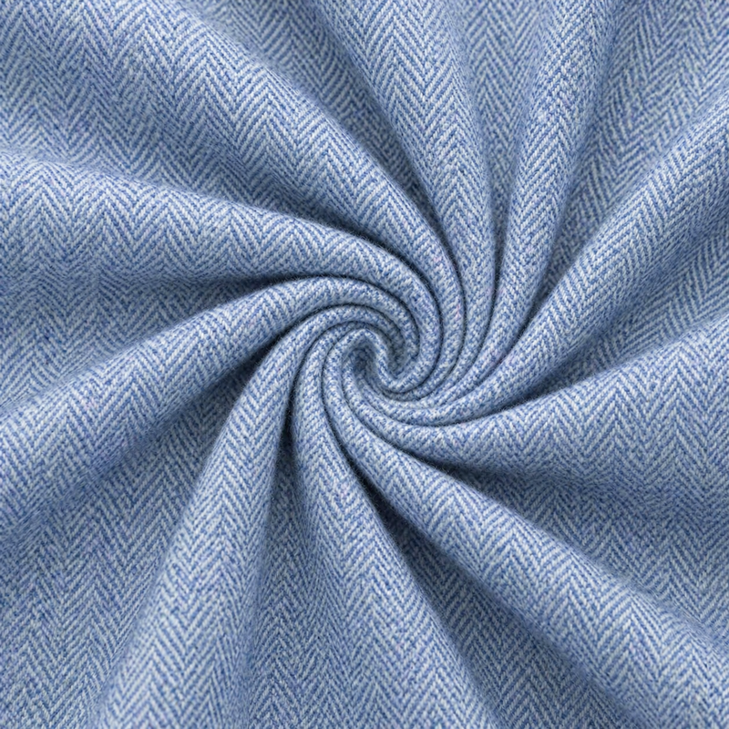 Close-up of blue fabric with a herringbone pattern