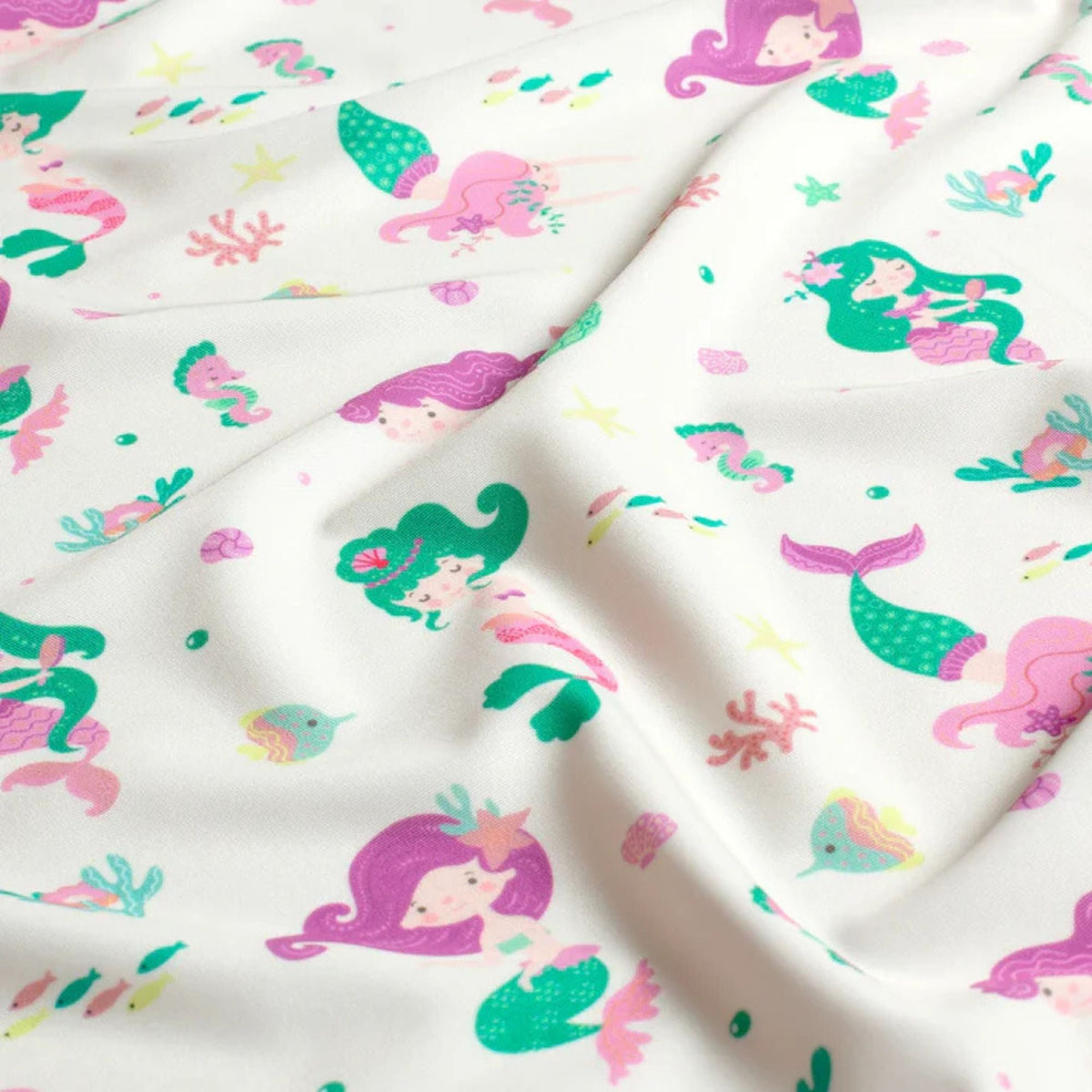 White swim fabric with playful pastel mermaid and ocean creature print – Oeko-Tex certified stretch knit for kids’ swimwear and beachwear projects