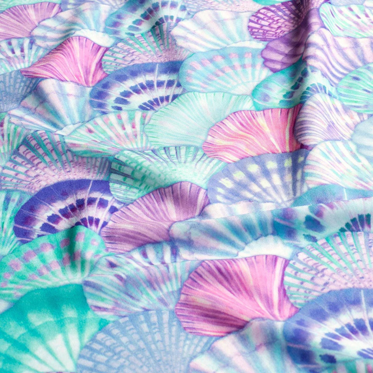 Swim fabric with colorful pastel seashell pattern in pink, aqua, purple, and blue – Oeko-Tex certified stretch knit for swimwear and beachwear projects