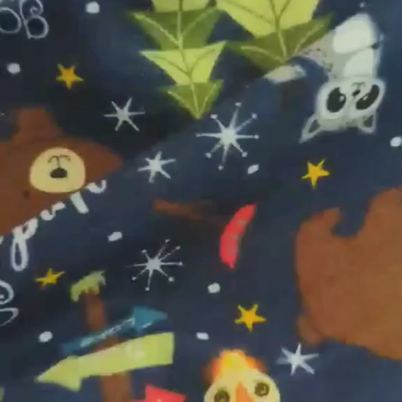 Camping-themed cotton flannel fabric with bears, raccoons, owls, tents, and stars on navy background, brushed soft, Oeko-Tex Standard 100, 44" wide.