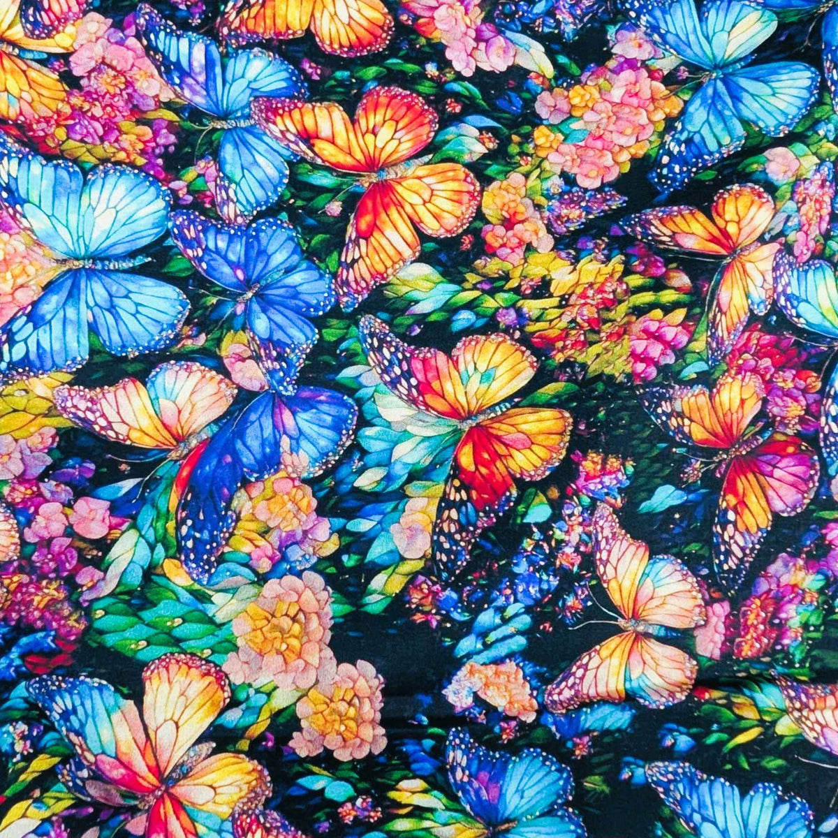 Stained glass butterfly fabric with vibrant blue, orange, and multicolored butterflies on a floral background – Gigi in the Garden 60-inch wide cotton backing