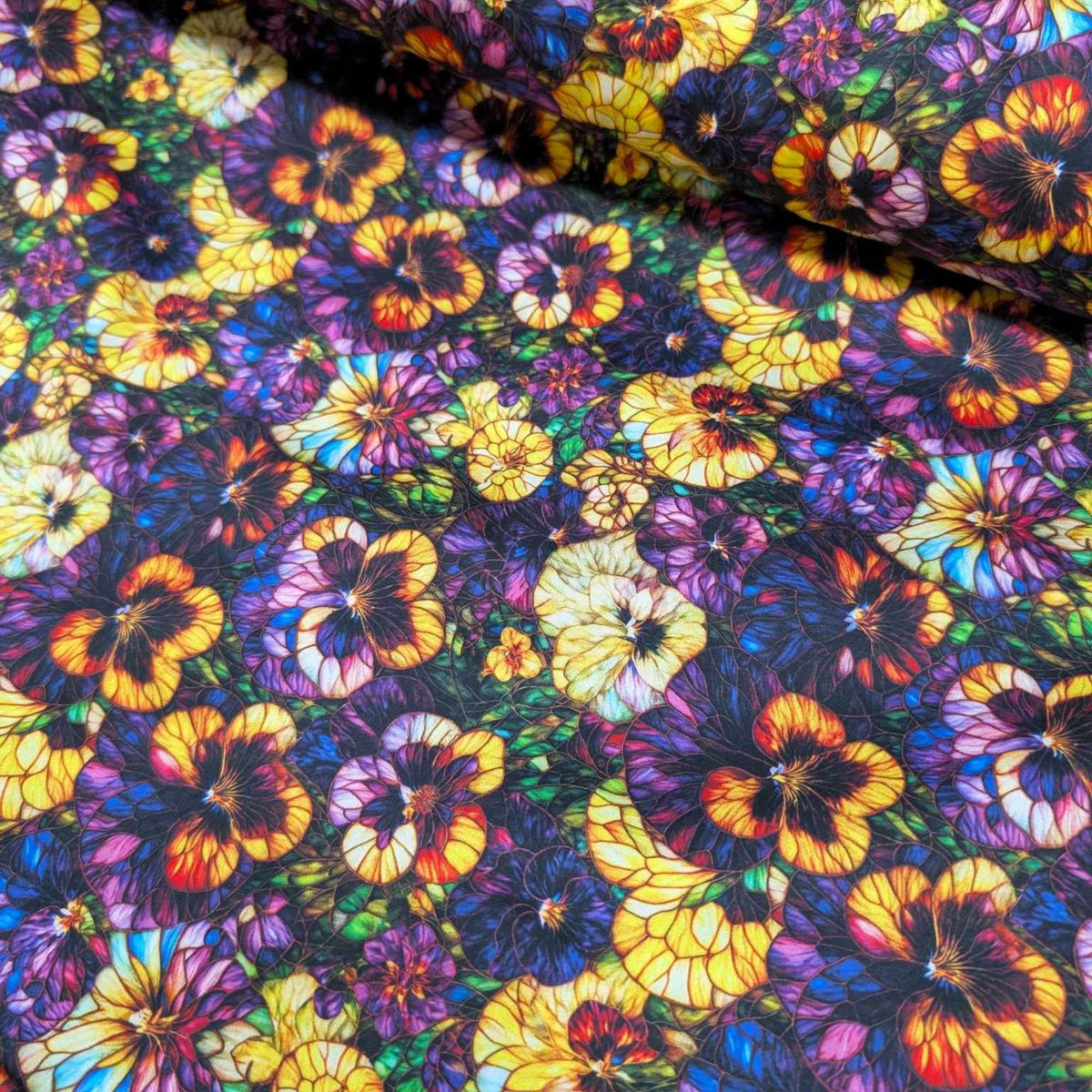 Stained glass-style pansy fabric with vibrant yellow, purple, and multicolored flowers – Gigi in the Garden 60-inch wide cotton quilt backing