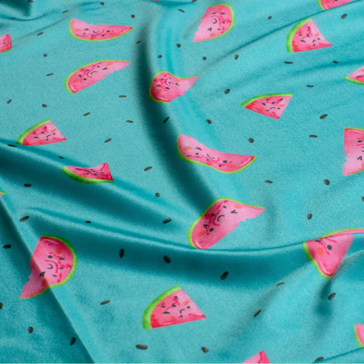 Bright aqua swim fabric with playful pink watermelon slices and seeds – Oeko-Tex certified stretch knit for kids’ swimwear and summer projects