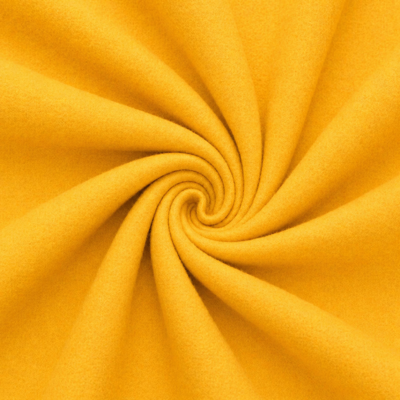 Close-up of yellow fabric with a swirl pattern