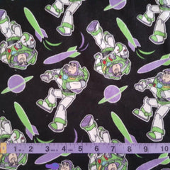 Tossed Buzz Lightyear FLANNEL from Toy Story on Black - Fabric Design Treasures